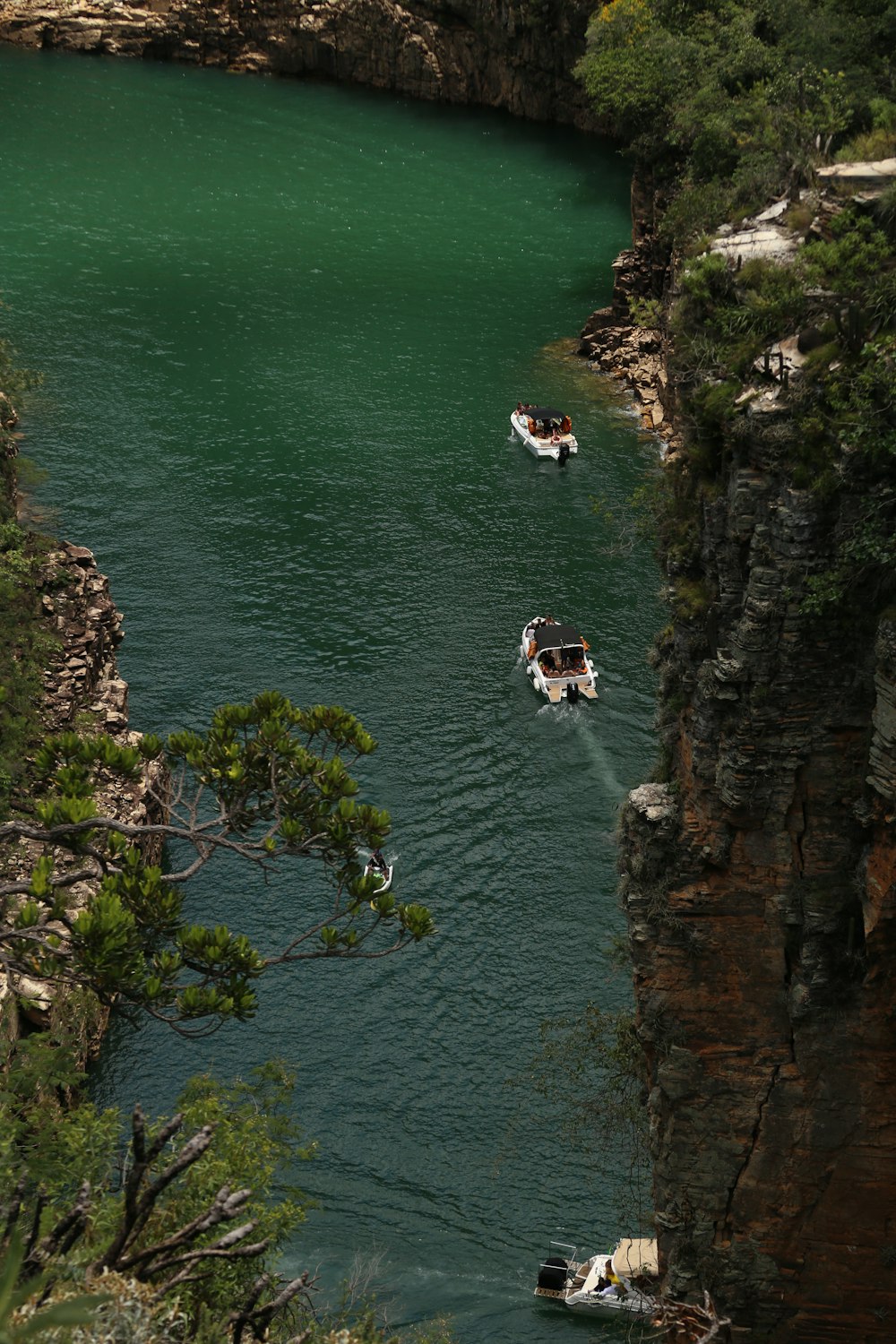 a group of boats floating on top of a river