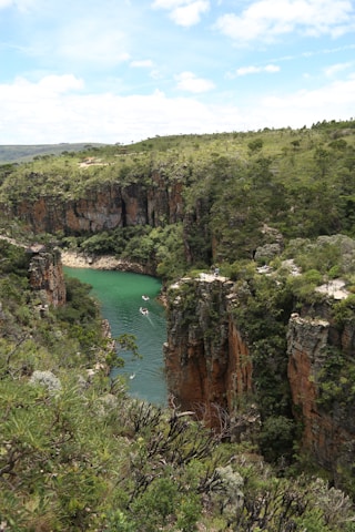 a river in the middle of a lush green valley