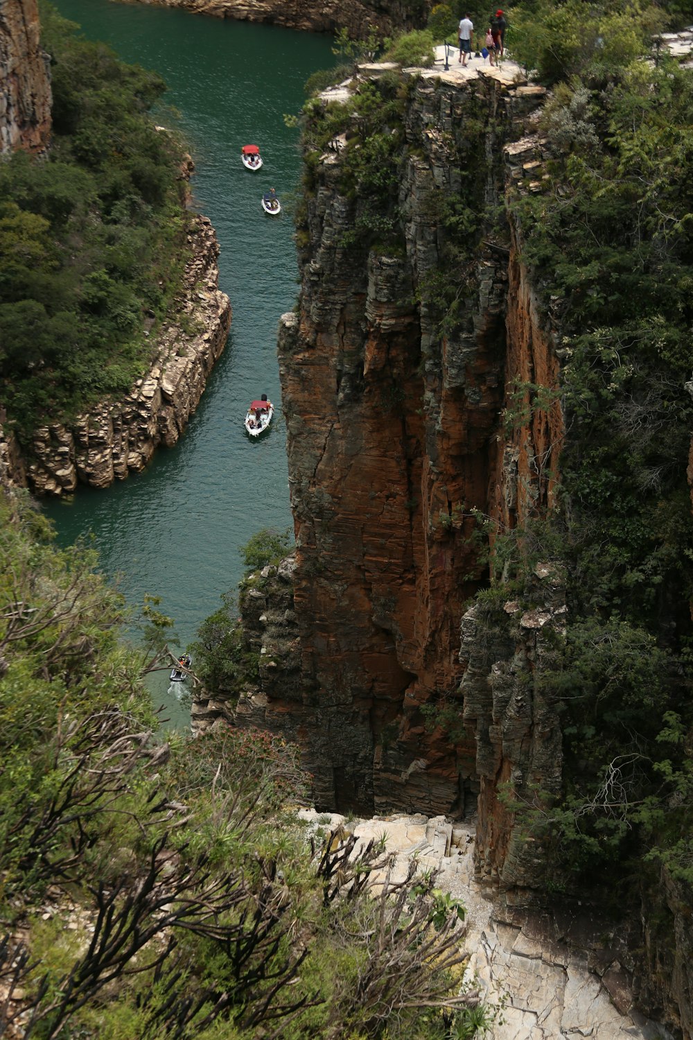 a group of people on small boats in a river