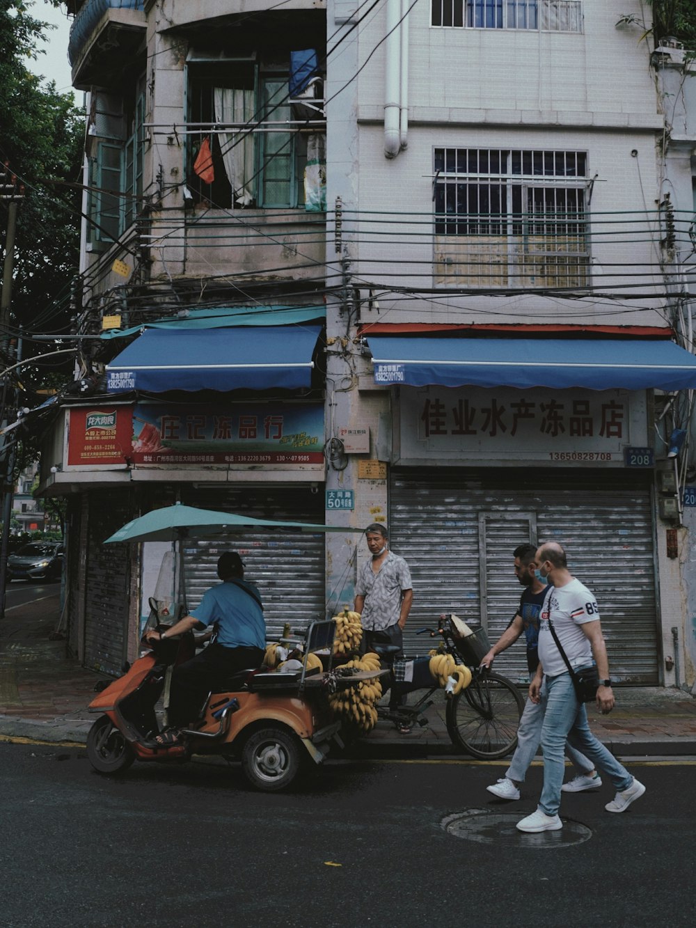 a group of people crossing a street in front of a building