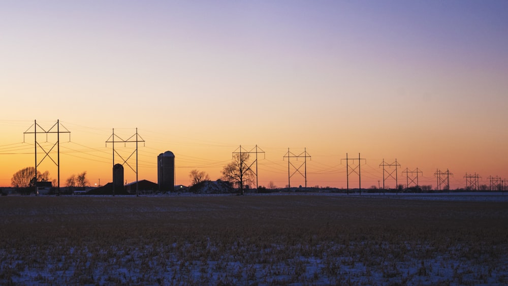 a field with power lines in the distance