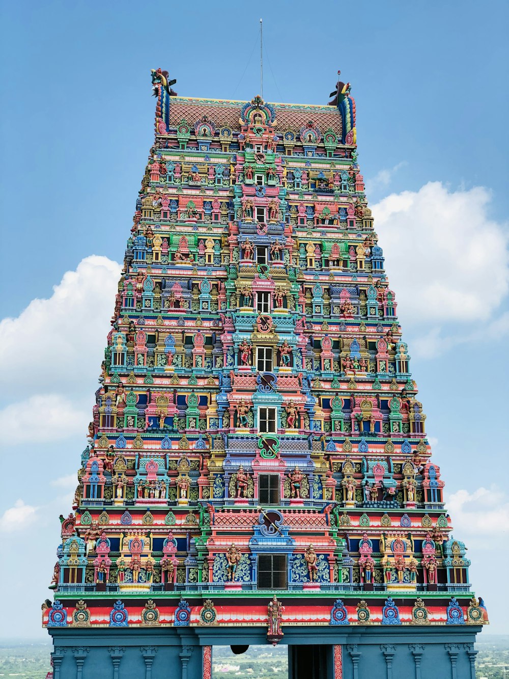 a very tall colorful building with a sky background