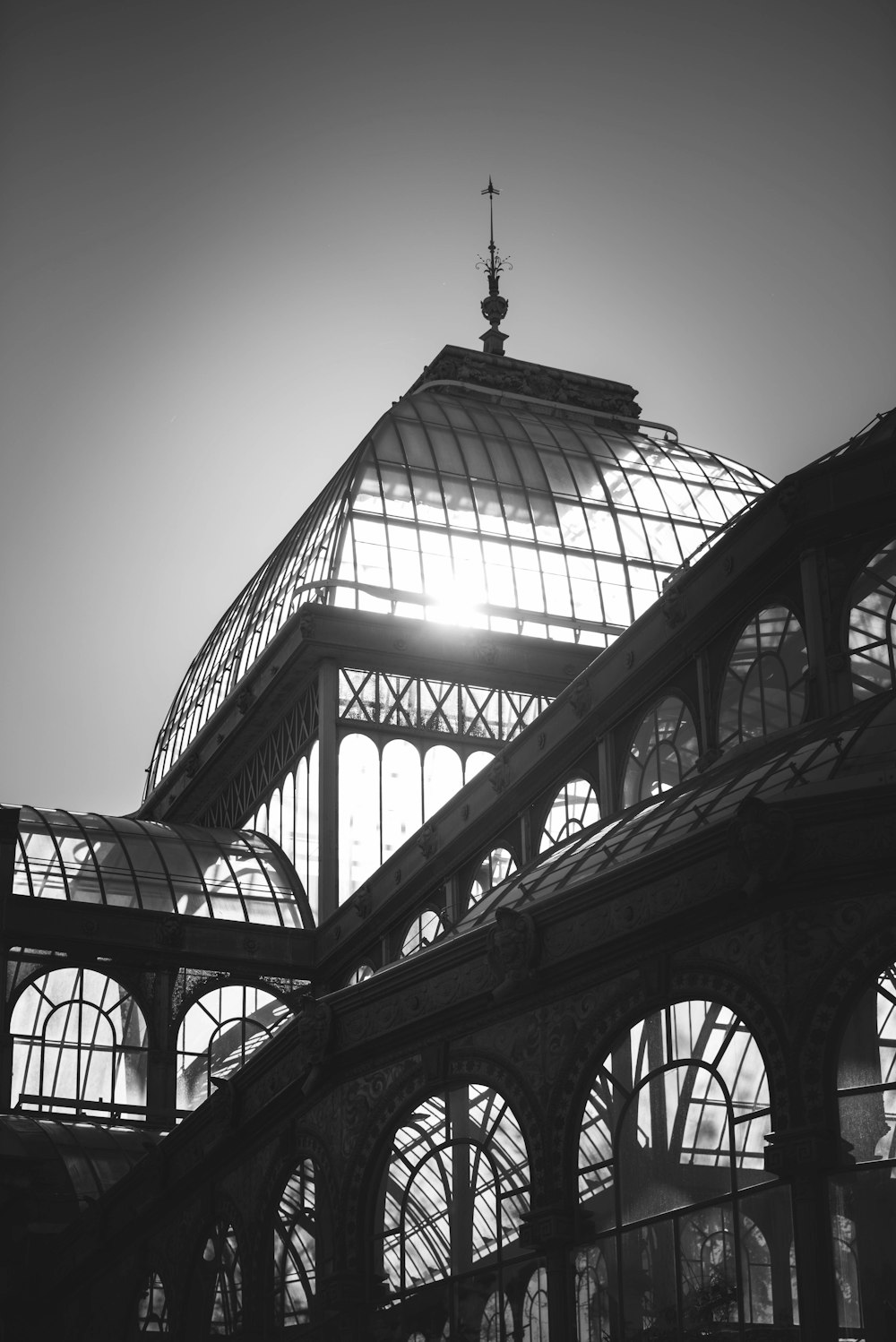 a black and white photo of a glass building