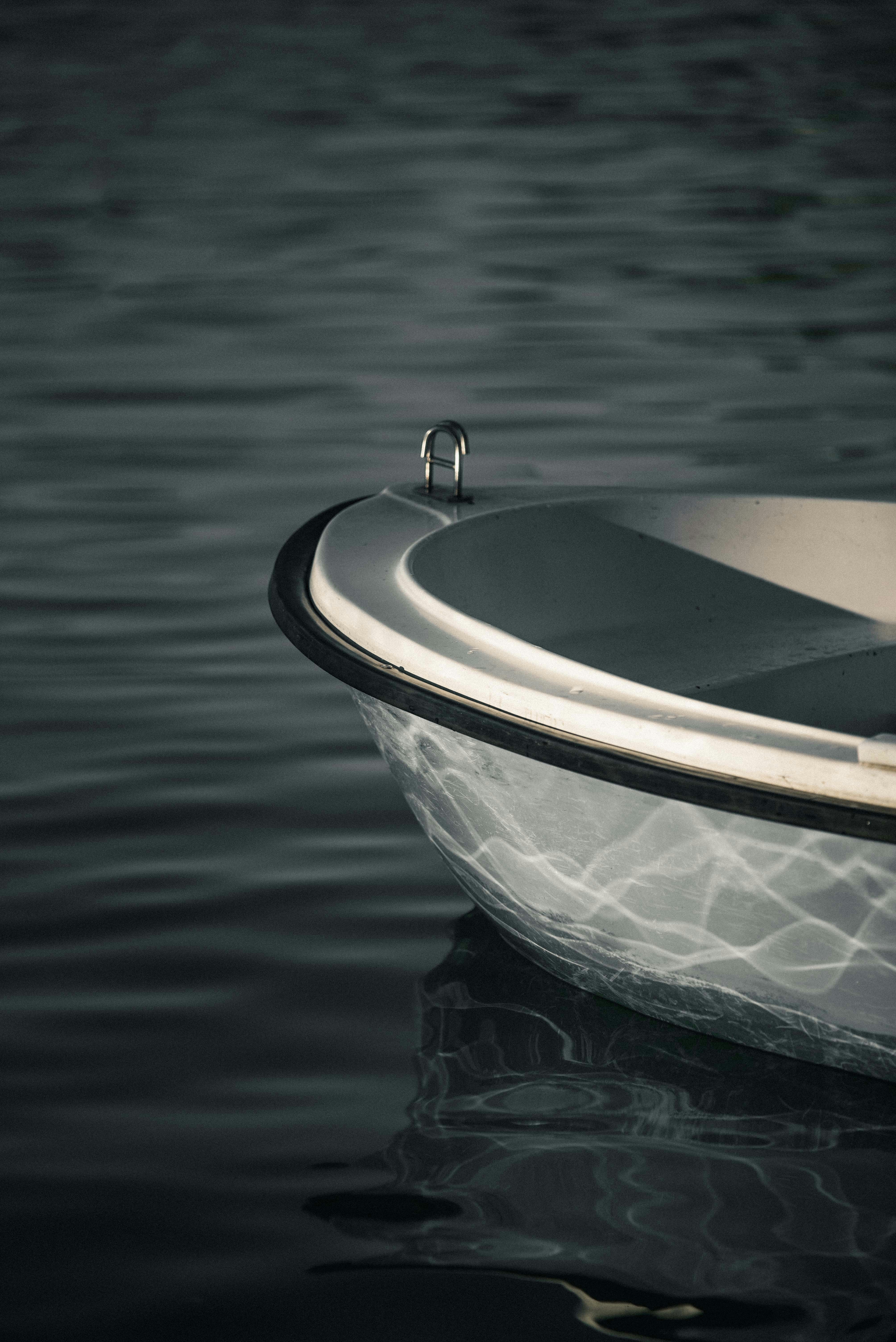 a small boat floating on top of a lake
