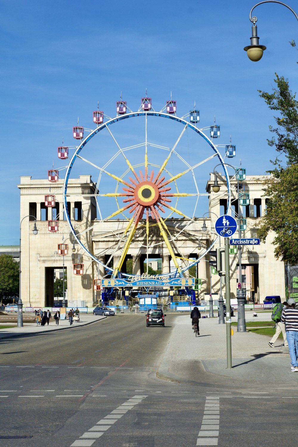 a large ferris wheel sitting on the side of a road