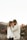 A couple embracing in a picturesque natural landscape.