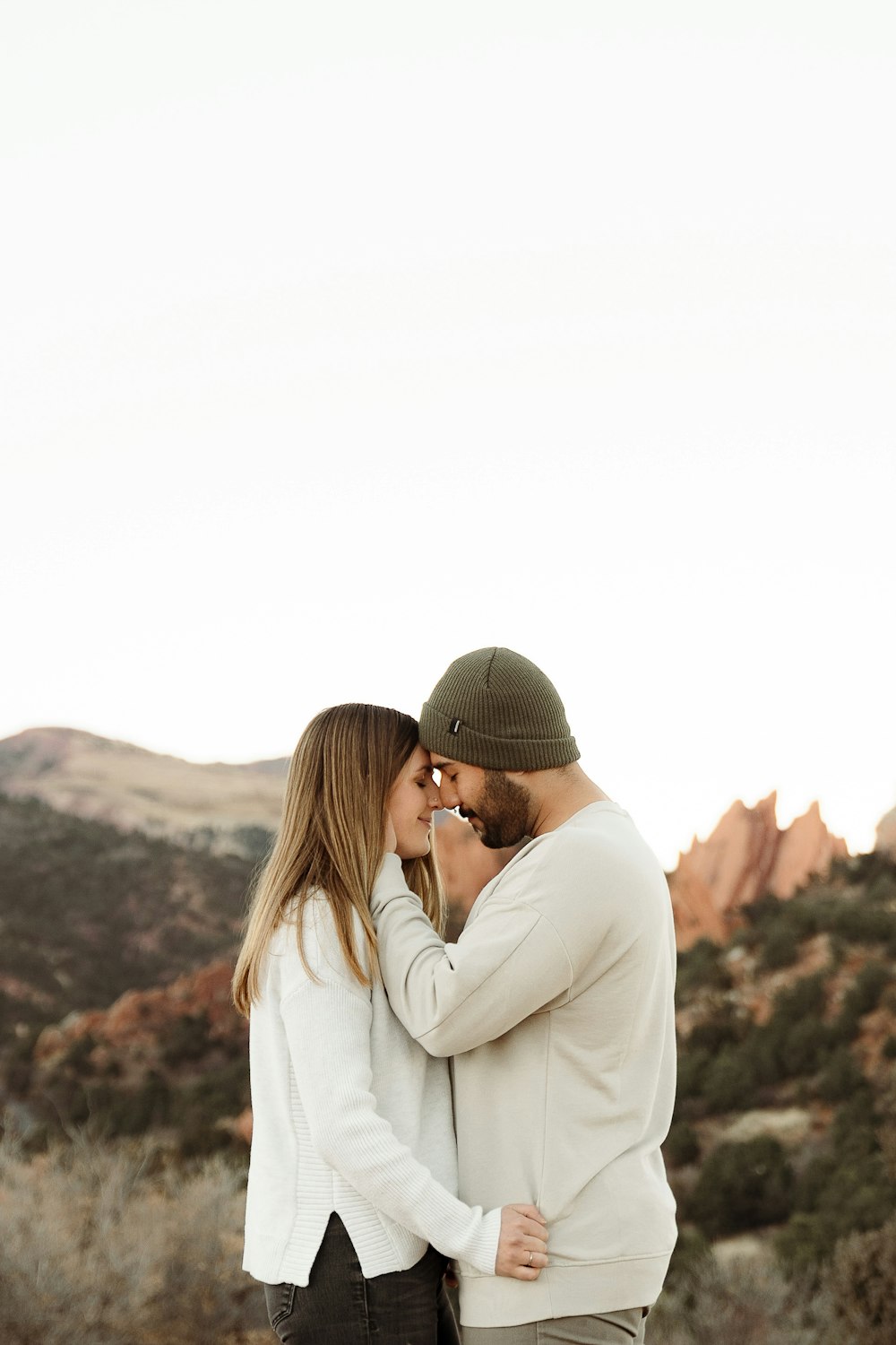 a man and a woman standing together in the desert