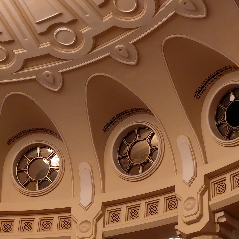 a domed ceiling with three circular windows in it