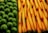 Close-up of fresh fruits and vegetables arranged neatly in a market display.