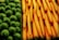 Close-up of fresh fruits and vegetables arranged neatly in a market display.