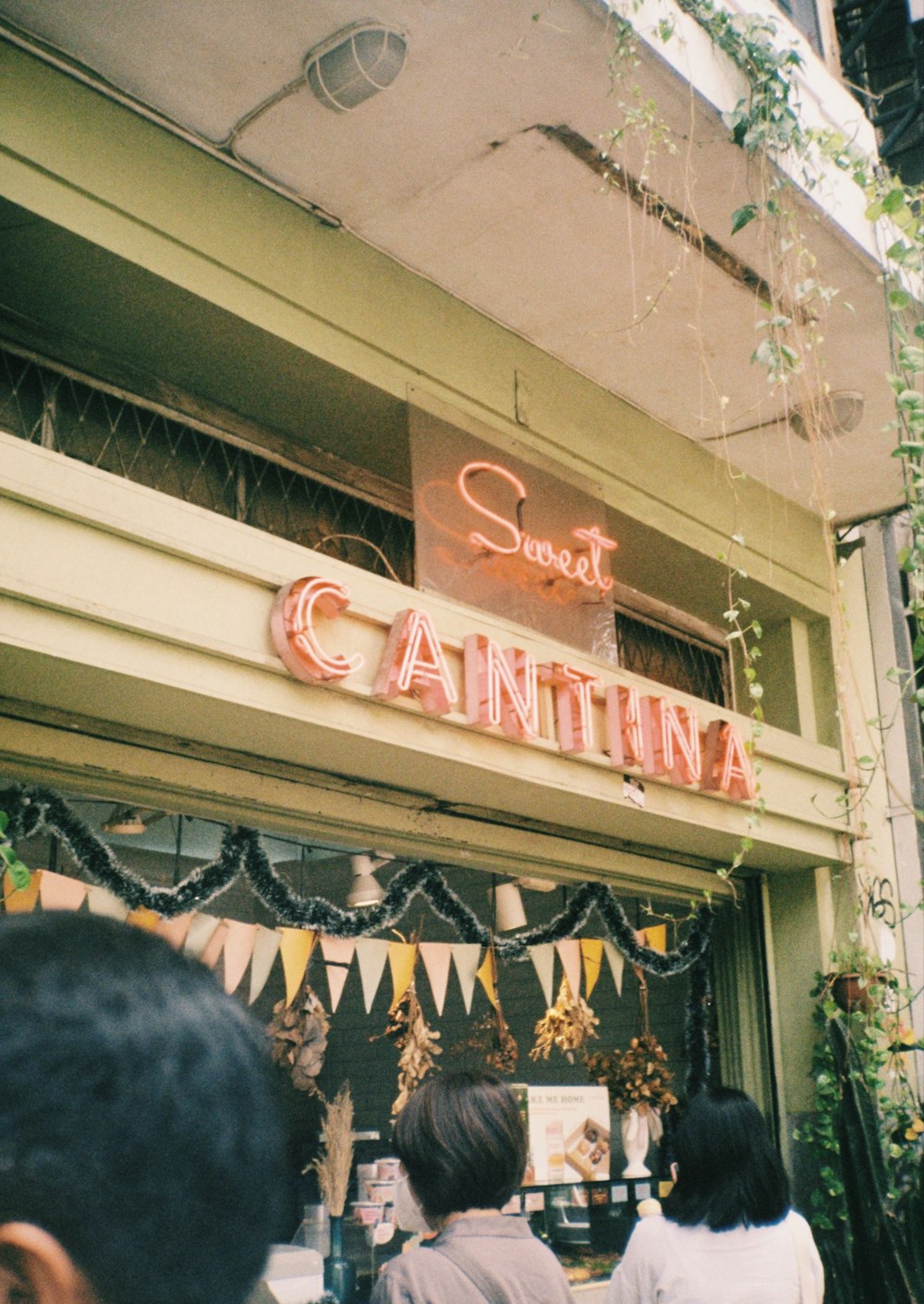 a group of people standing outside of a store