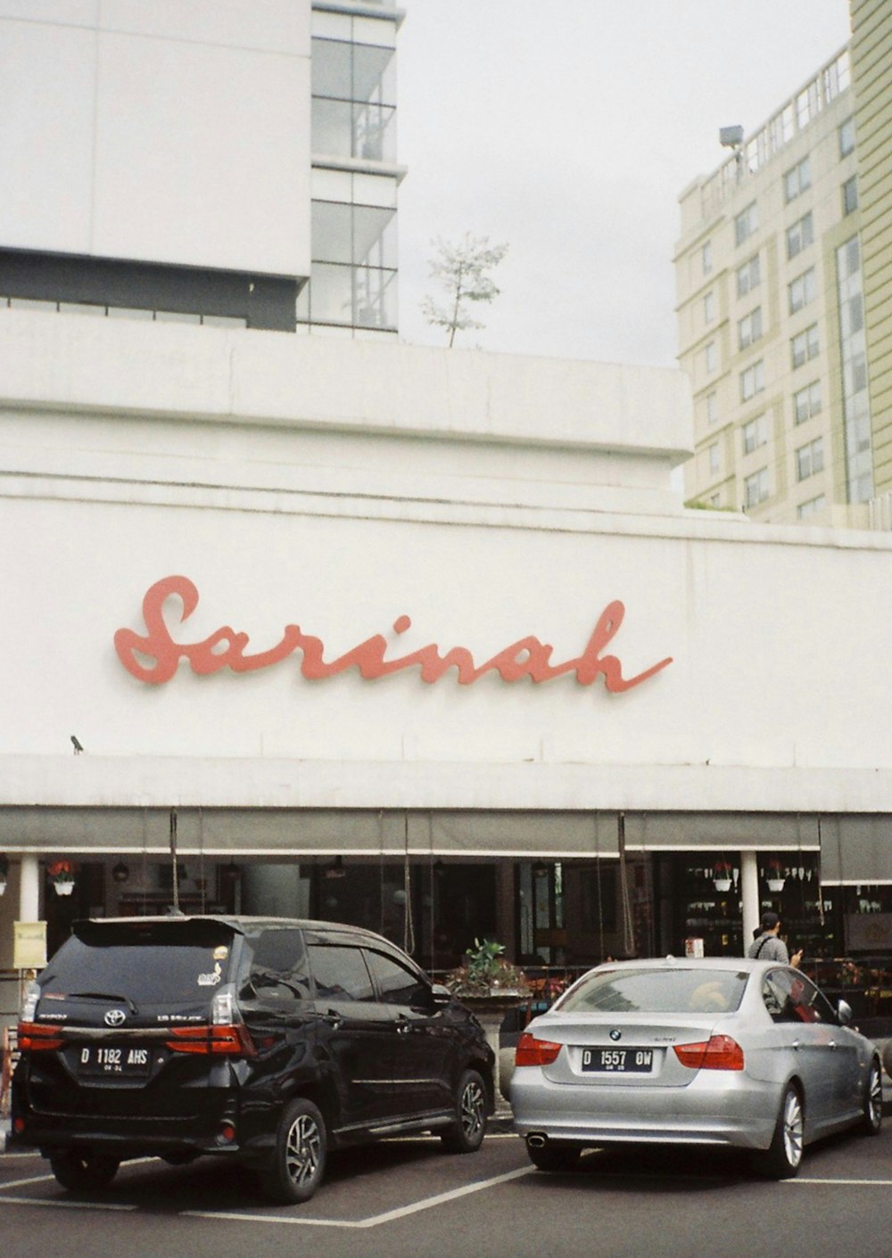 cars parked in a parking lot in front of a restaurant