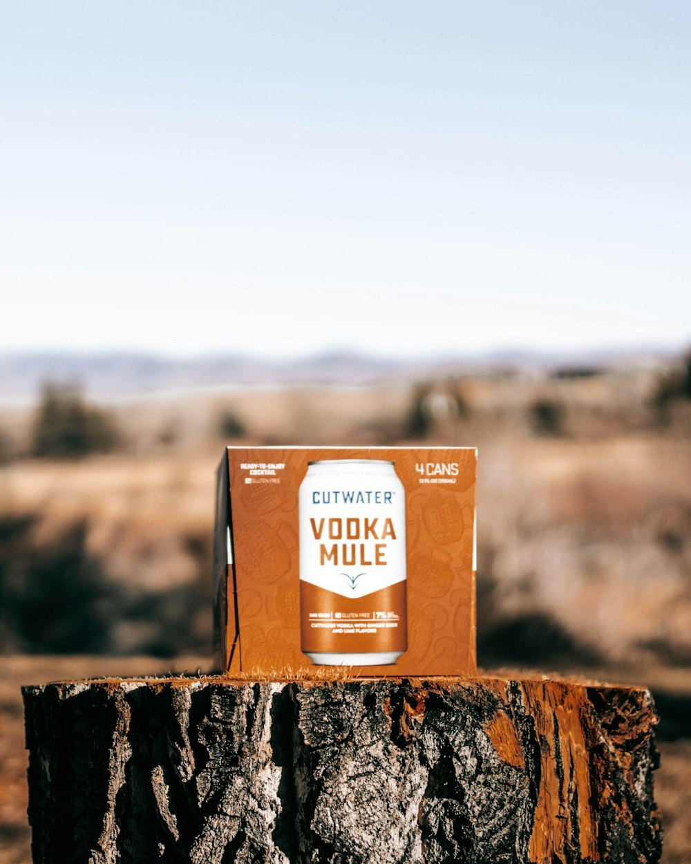 a box of vodka mule sitting on top of a tree stump
