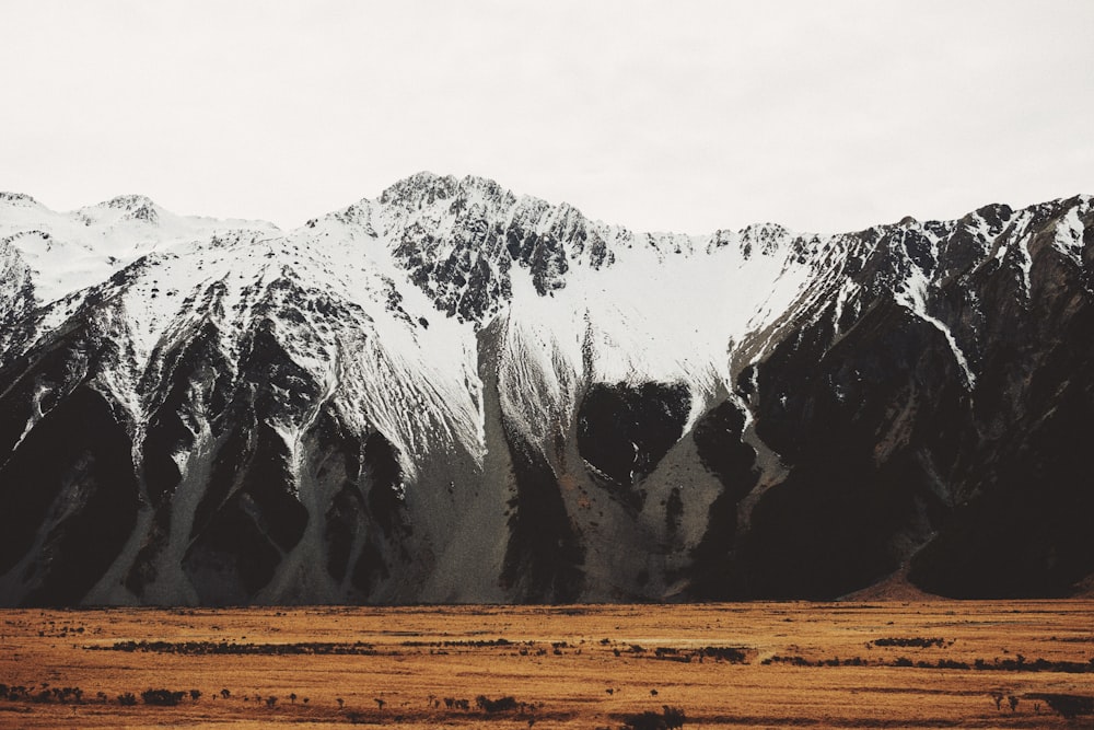 a snow covered mountain range in the distance