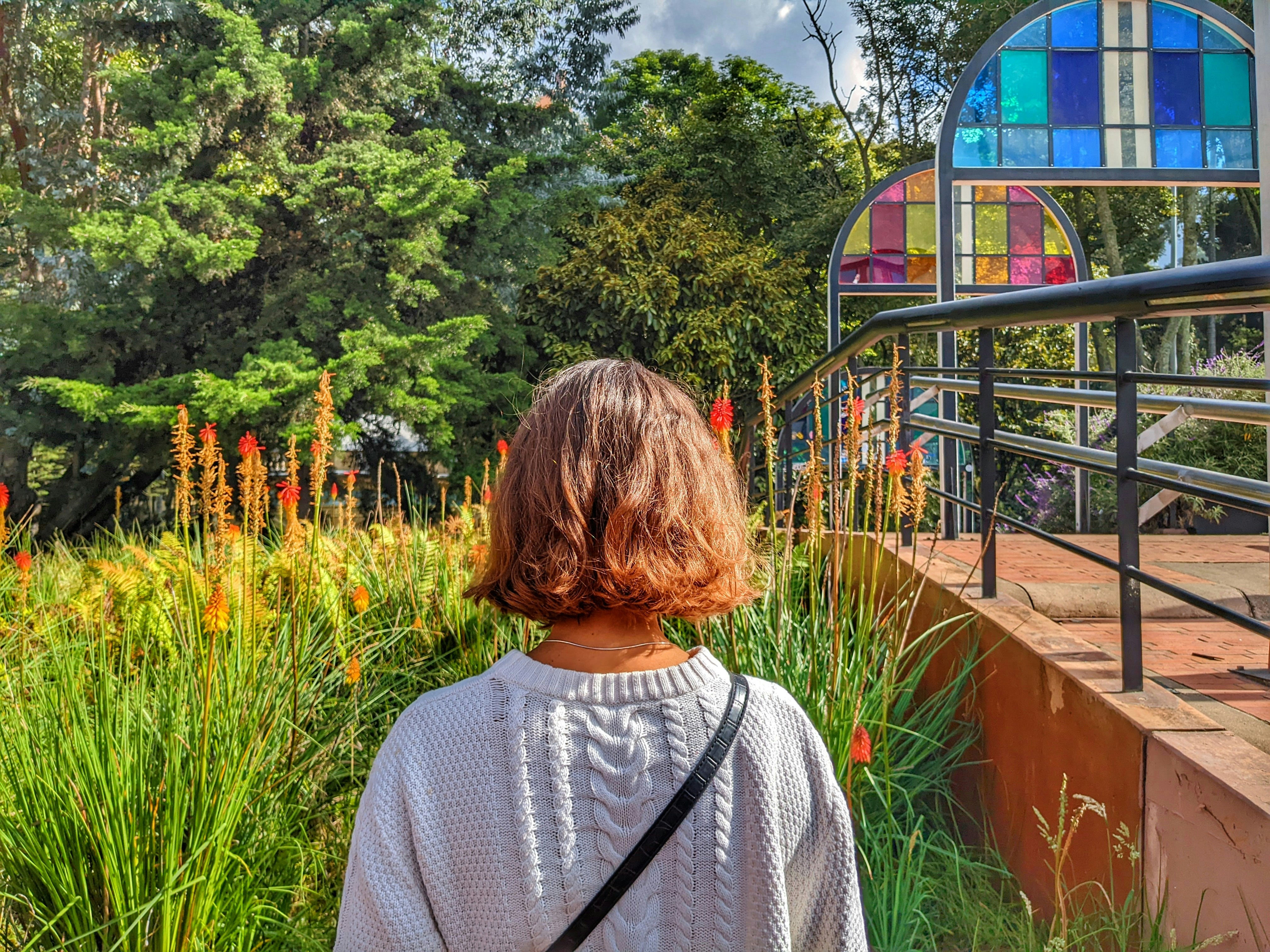 a woman standing in front of a colorful building