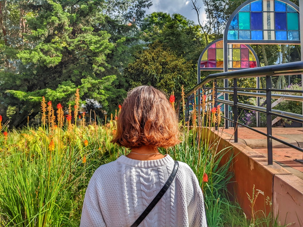 a woman standing in front of a colorful building