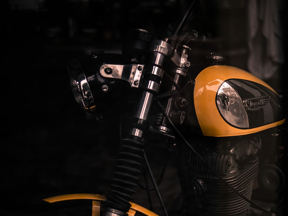 a close up of a motorcycle parked in the dark