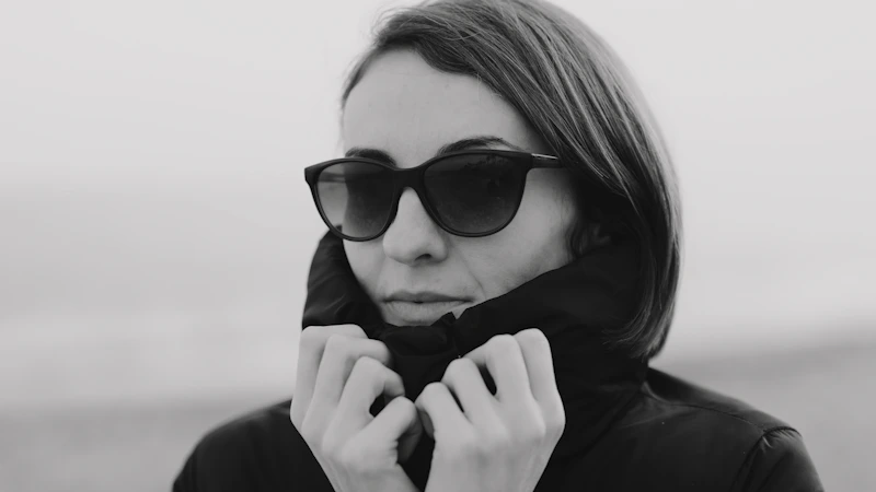 a woman wearing sunglasses and a black jacket