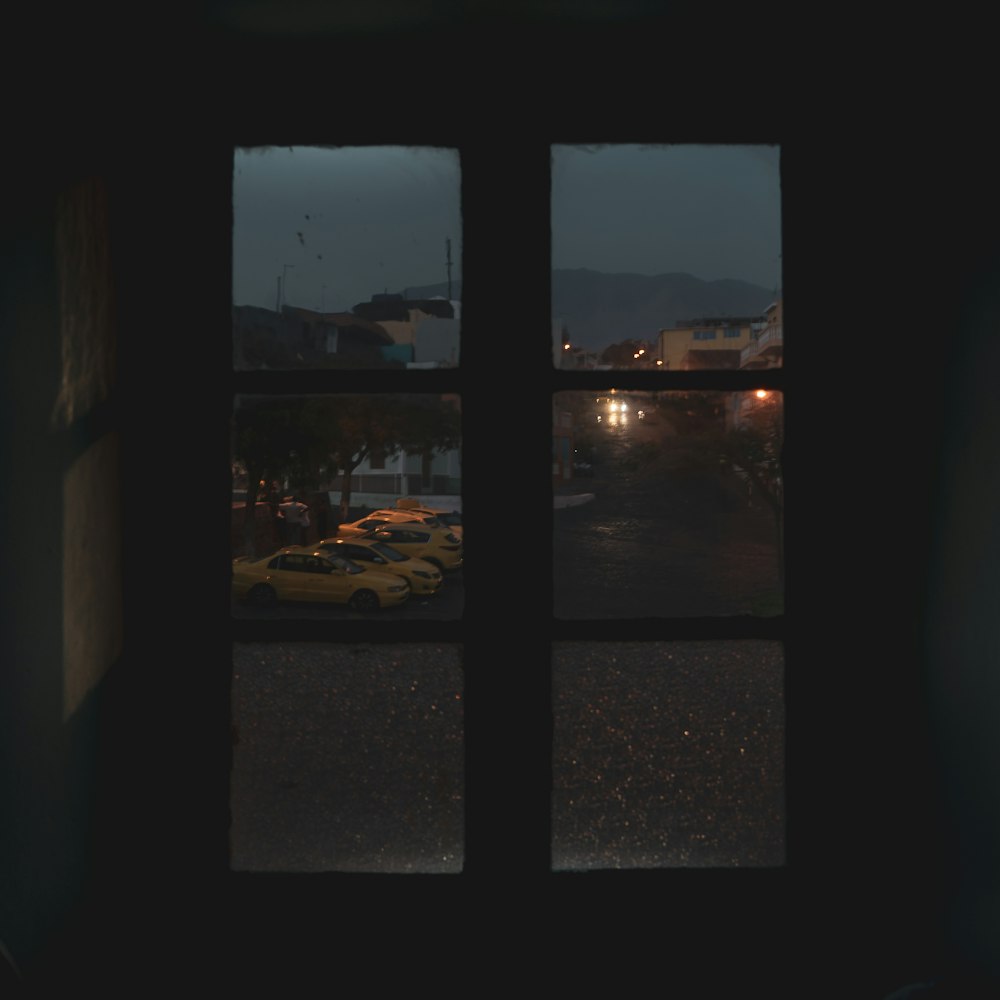 a window with a view of a parking lot at night
