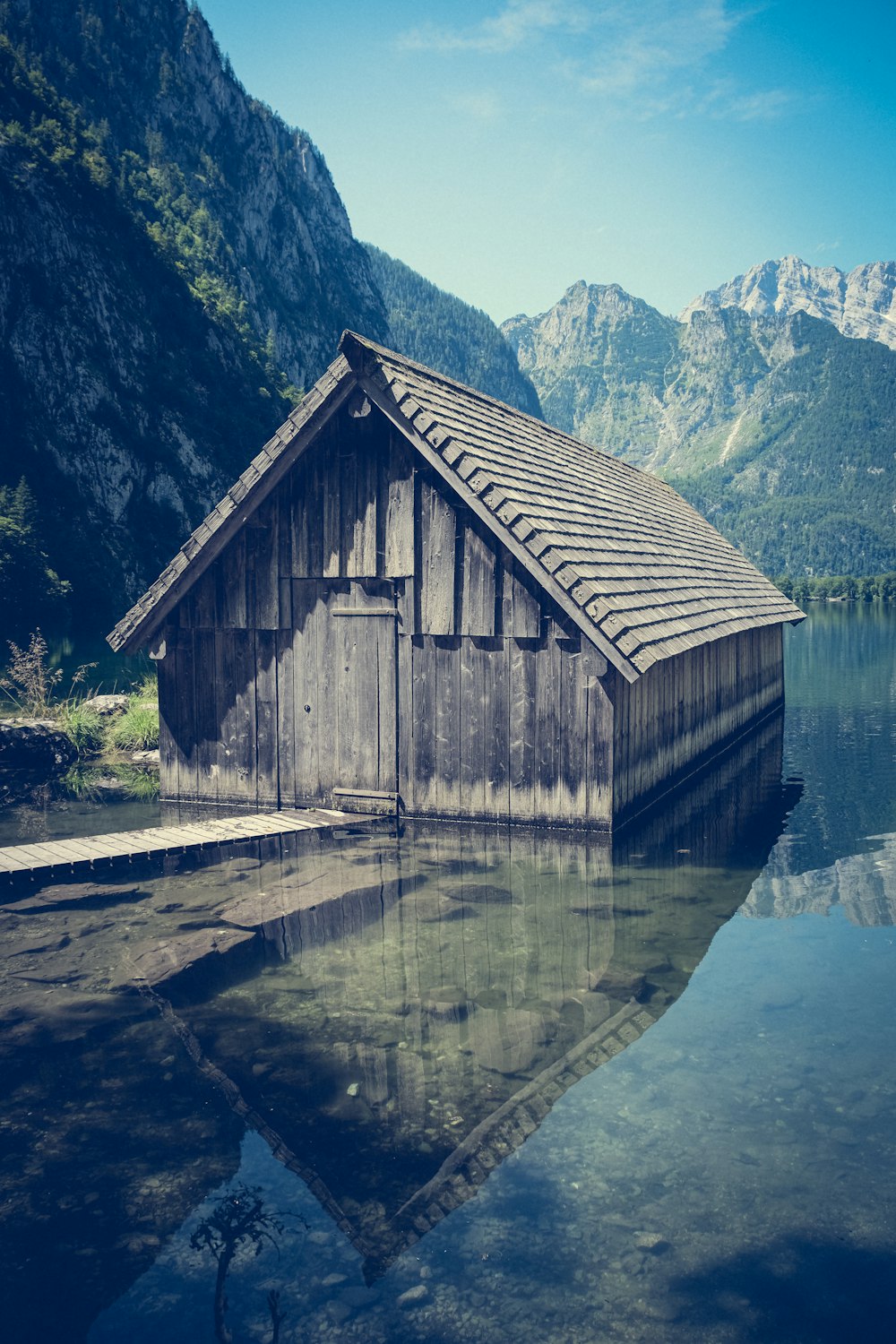 a wooden building sitting next to a body of water