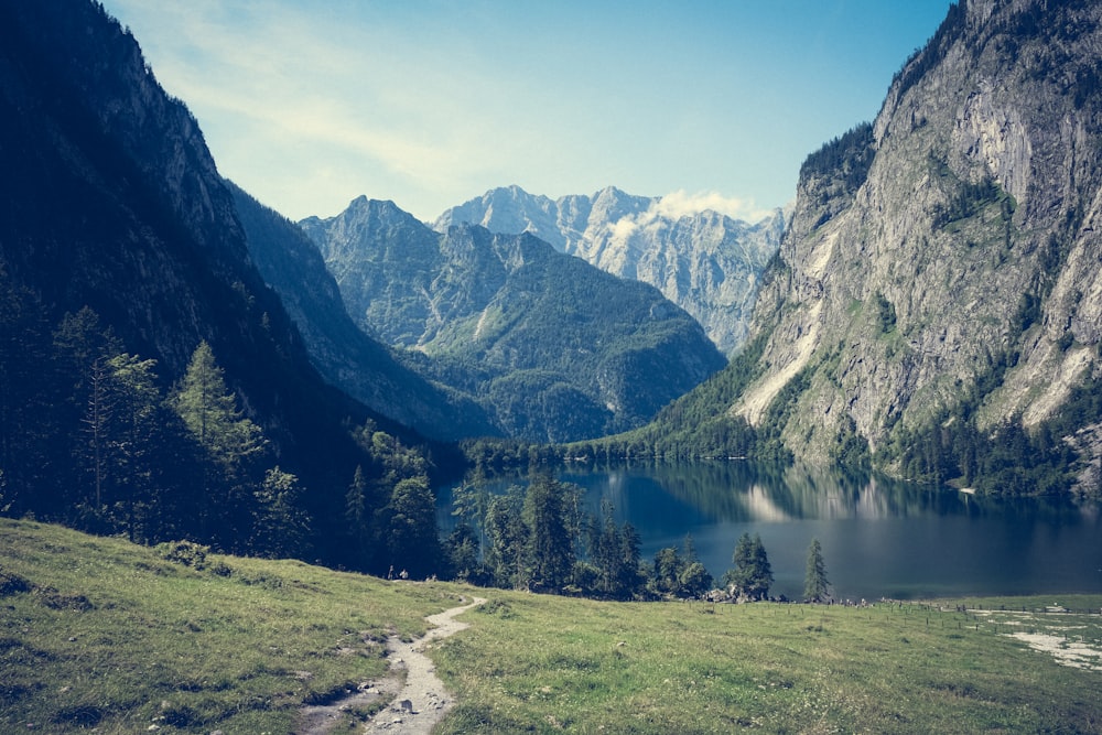 a view of a mountain range with a lake in the foreground