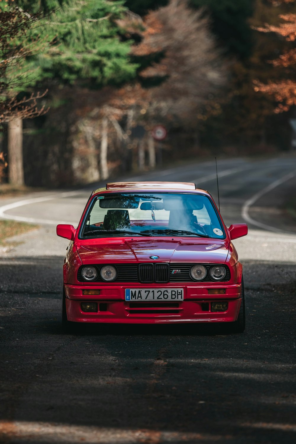 a red car parked on the side of a road