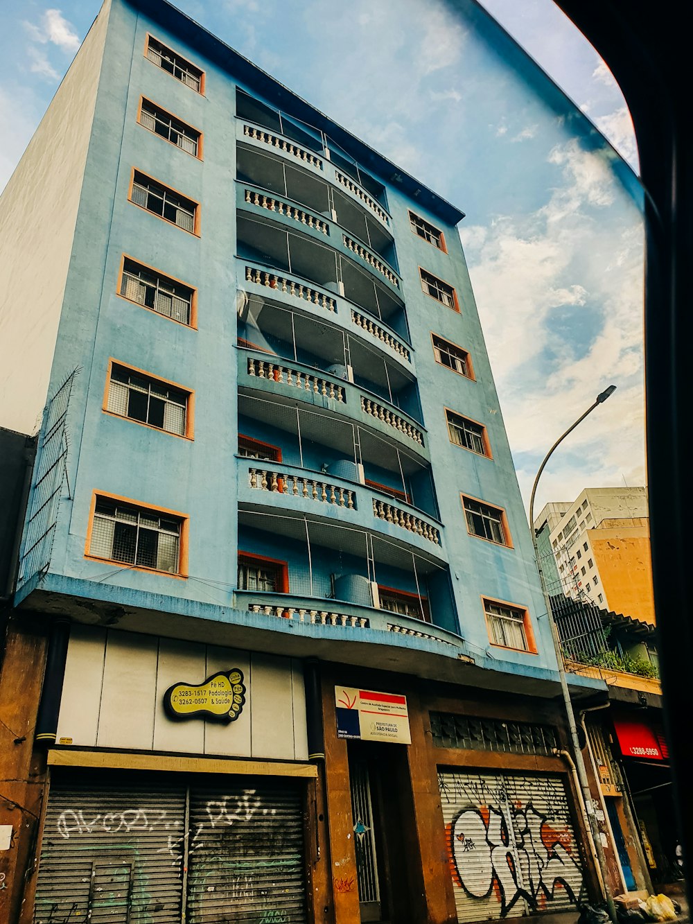 a tall blue building with lots of windows