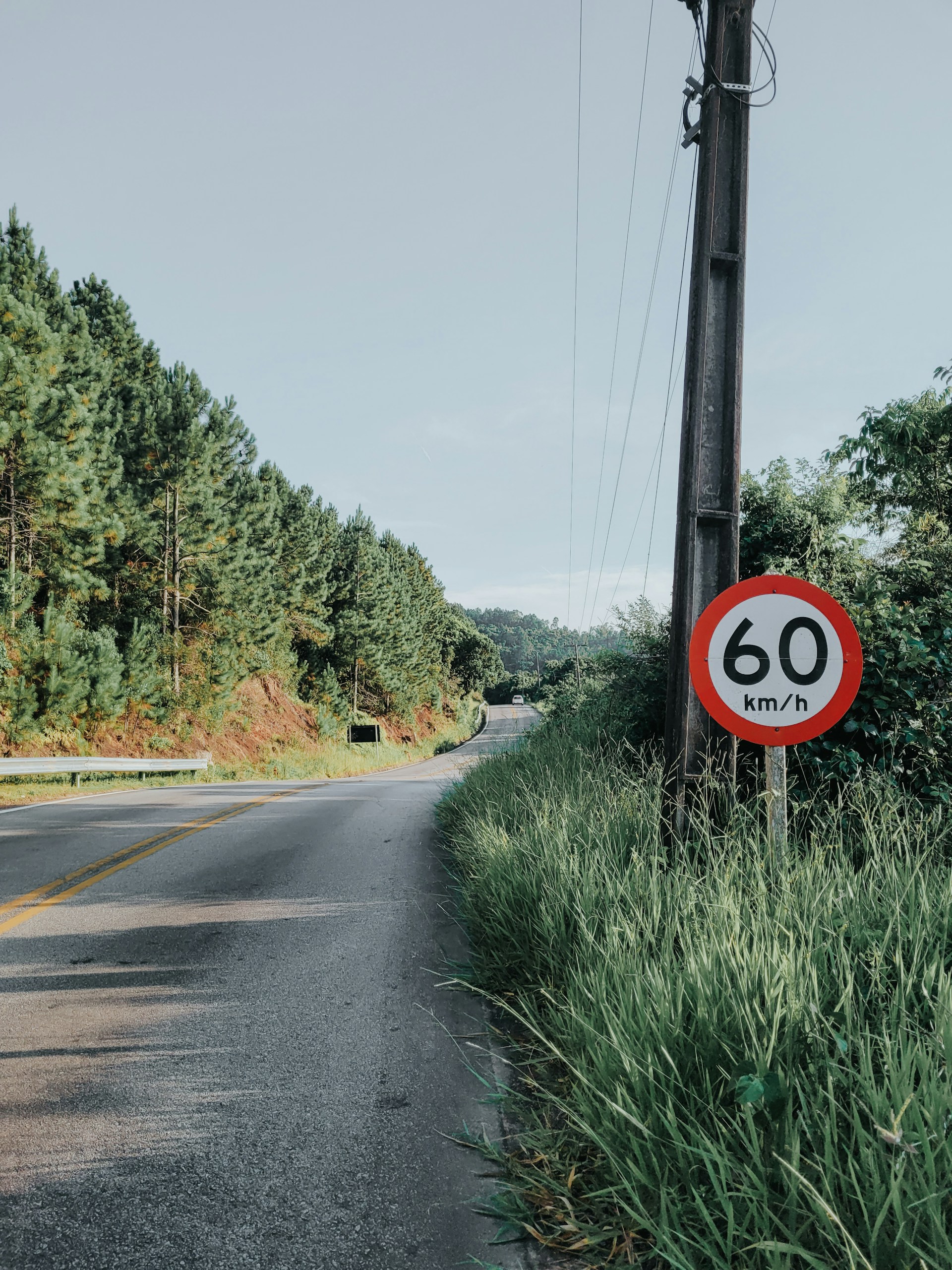 a red and white sign sitting on the side of a road