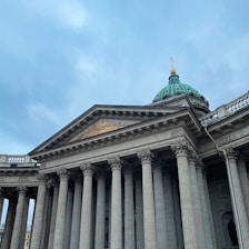 Elegant campus building with deep green and gold accents reflecting the institution's colors.