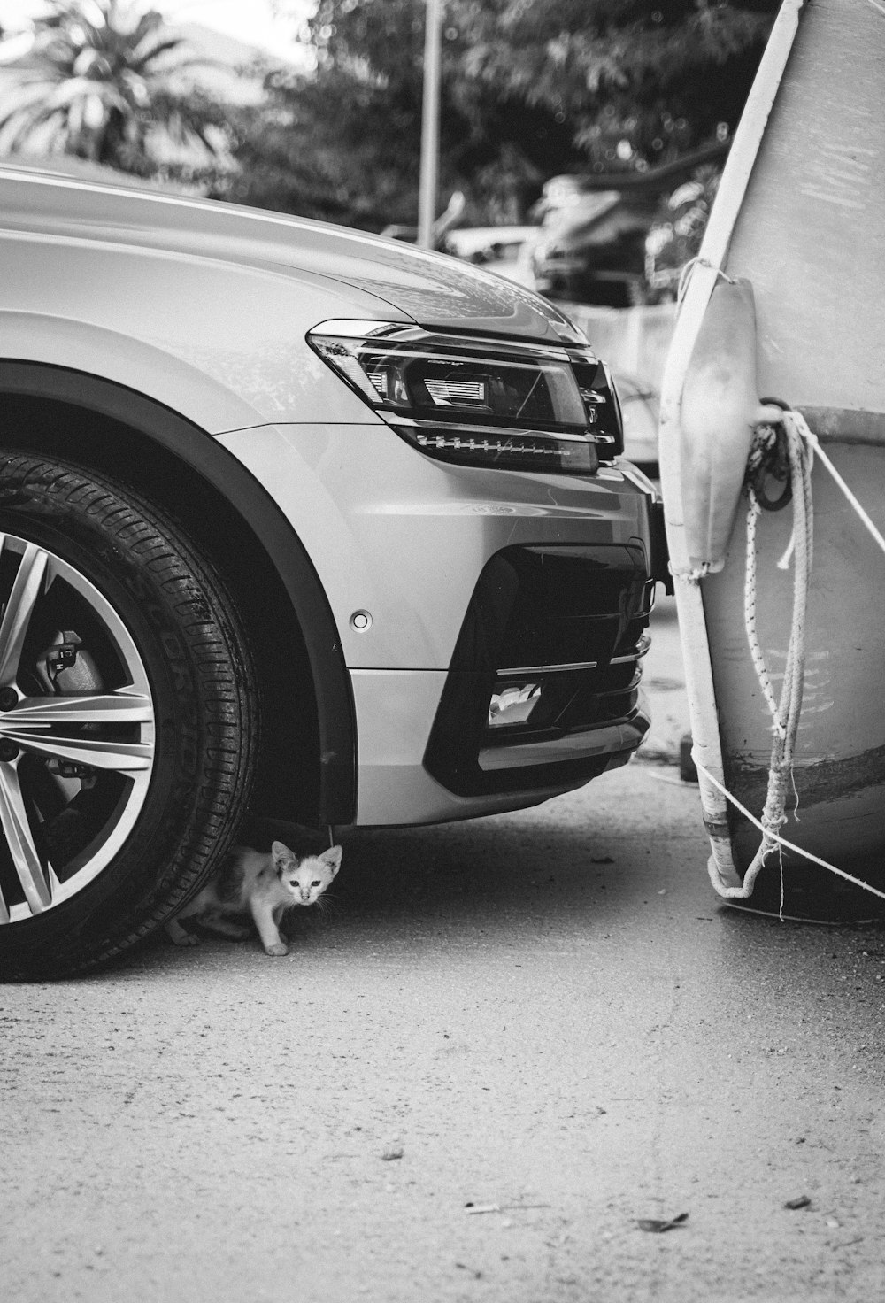 a car parked next to a boat on the street