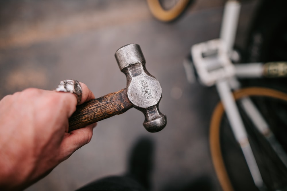 a close up of a person holding a wrench