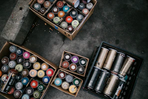 A display of various grease tubes and lubricant cans ready for shipment