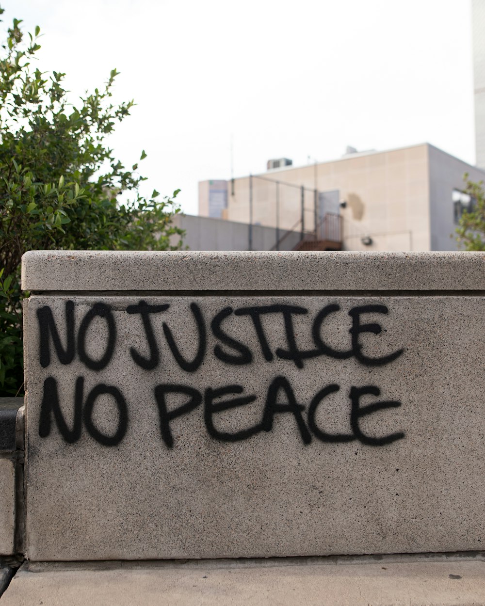 a cement wall with graffiti written on it