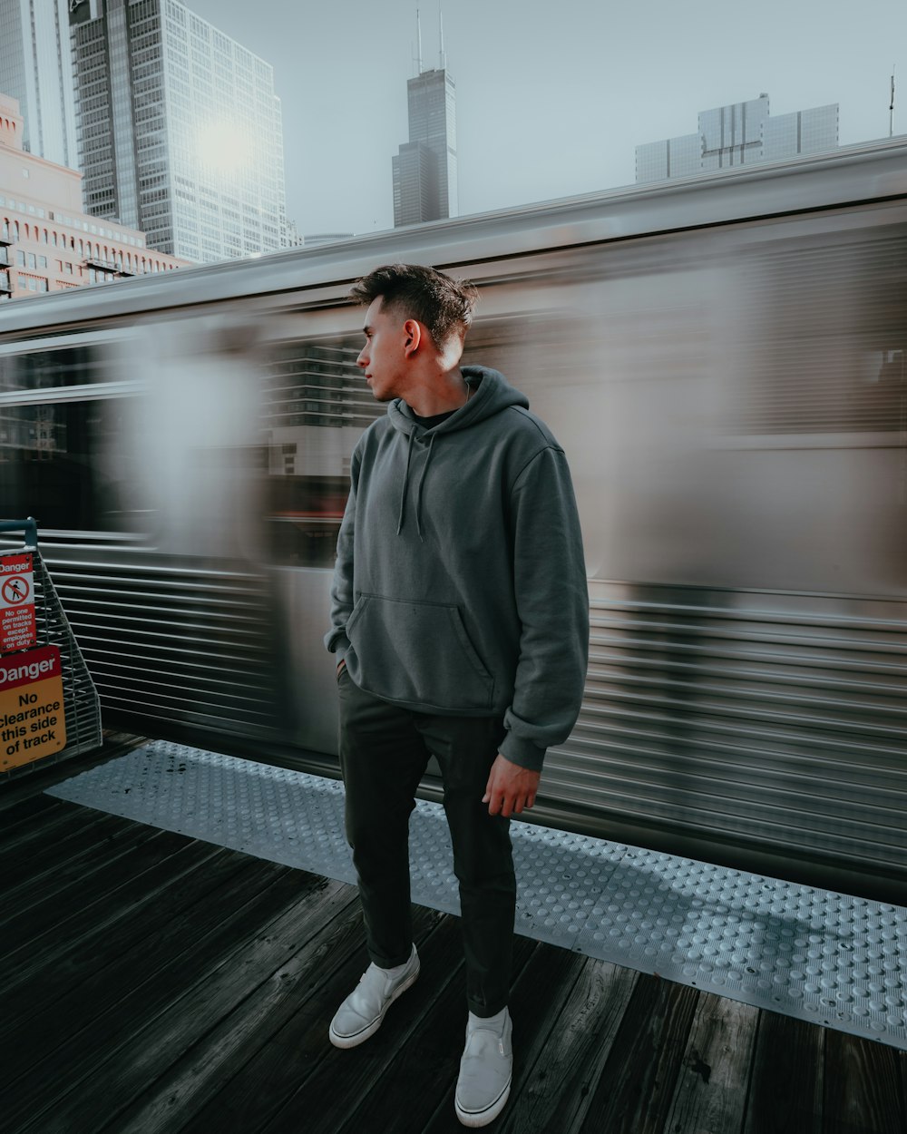 a man standing on a platform in front of a train