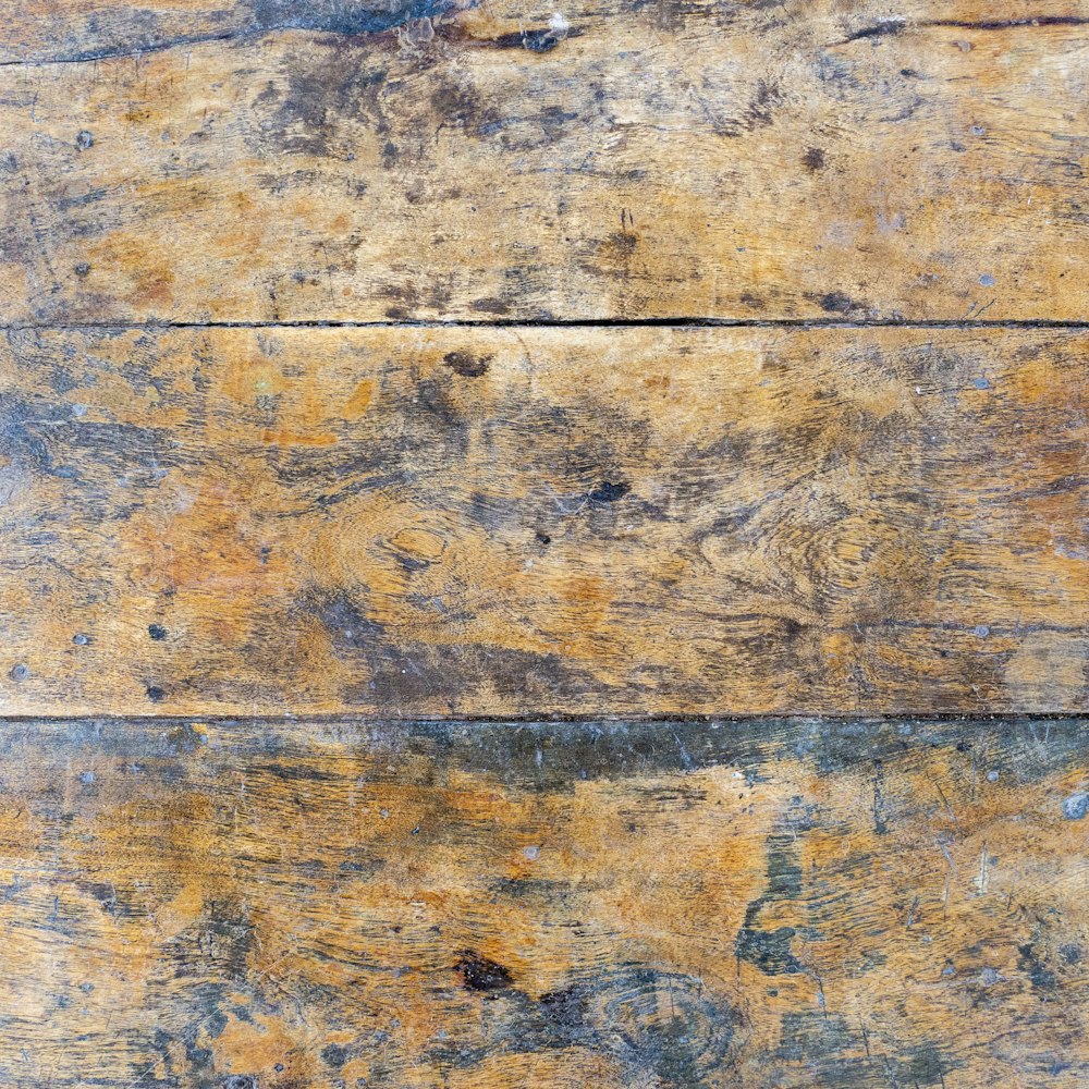 a close up of a wooden surface with peeling paint