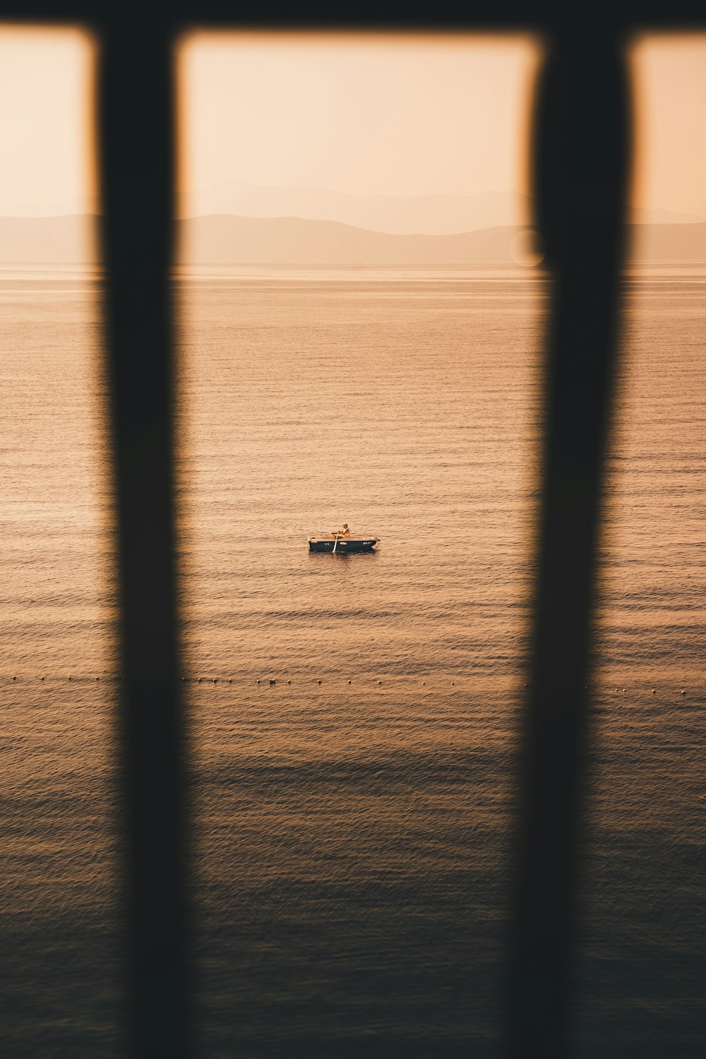 a couple of boats floating on top of a large body of water