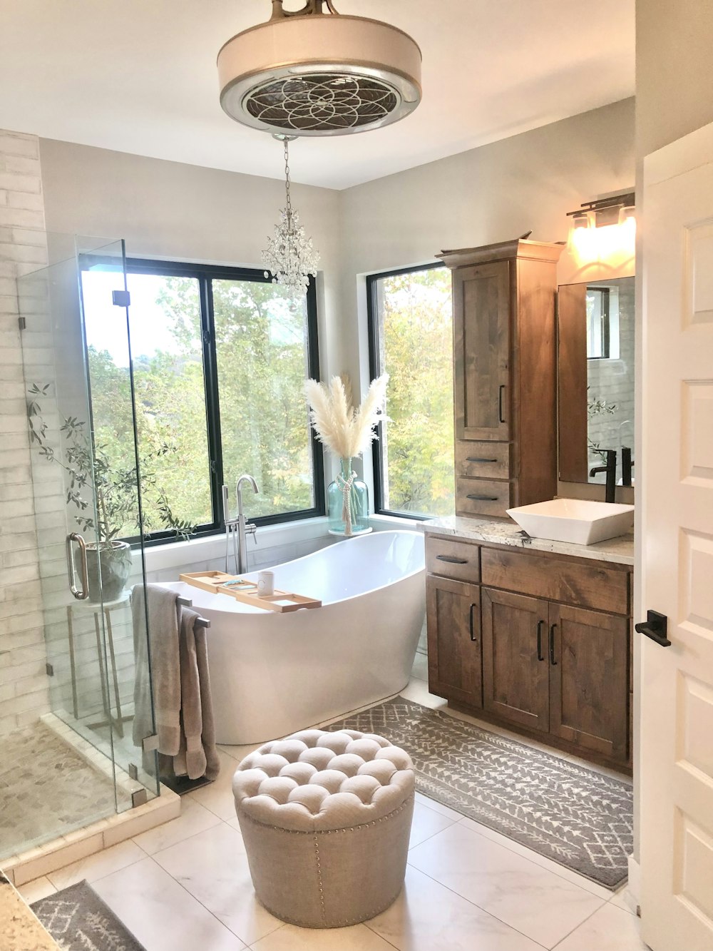 a bathroom with a tub and a large window