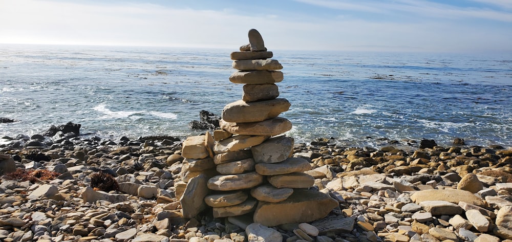 a stack of rocks sitting on top of a rocky beach