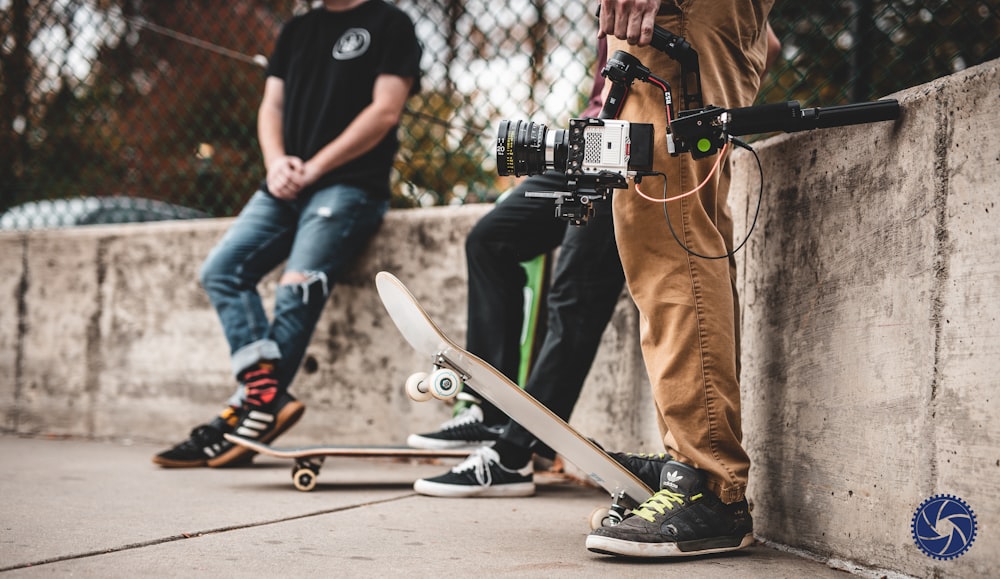 a couple of people standing next to each other with skateboards