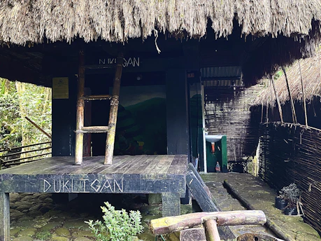 a wooden bench sitting in front of a hut