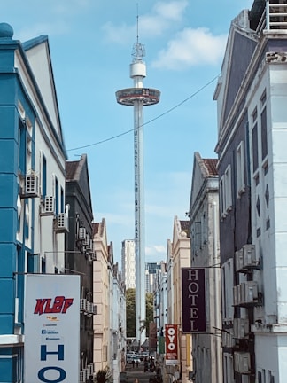 a city street with a tall tower in the background