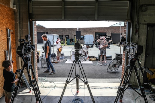 a group of people standing around a camera set up
