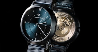 a close up of a watch on a black background