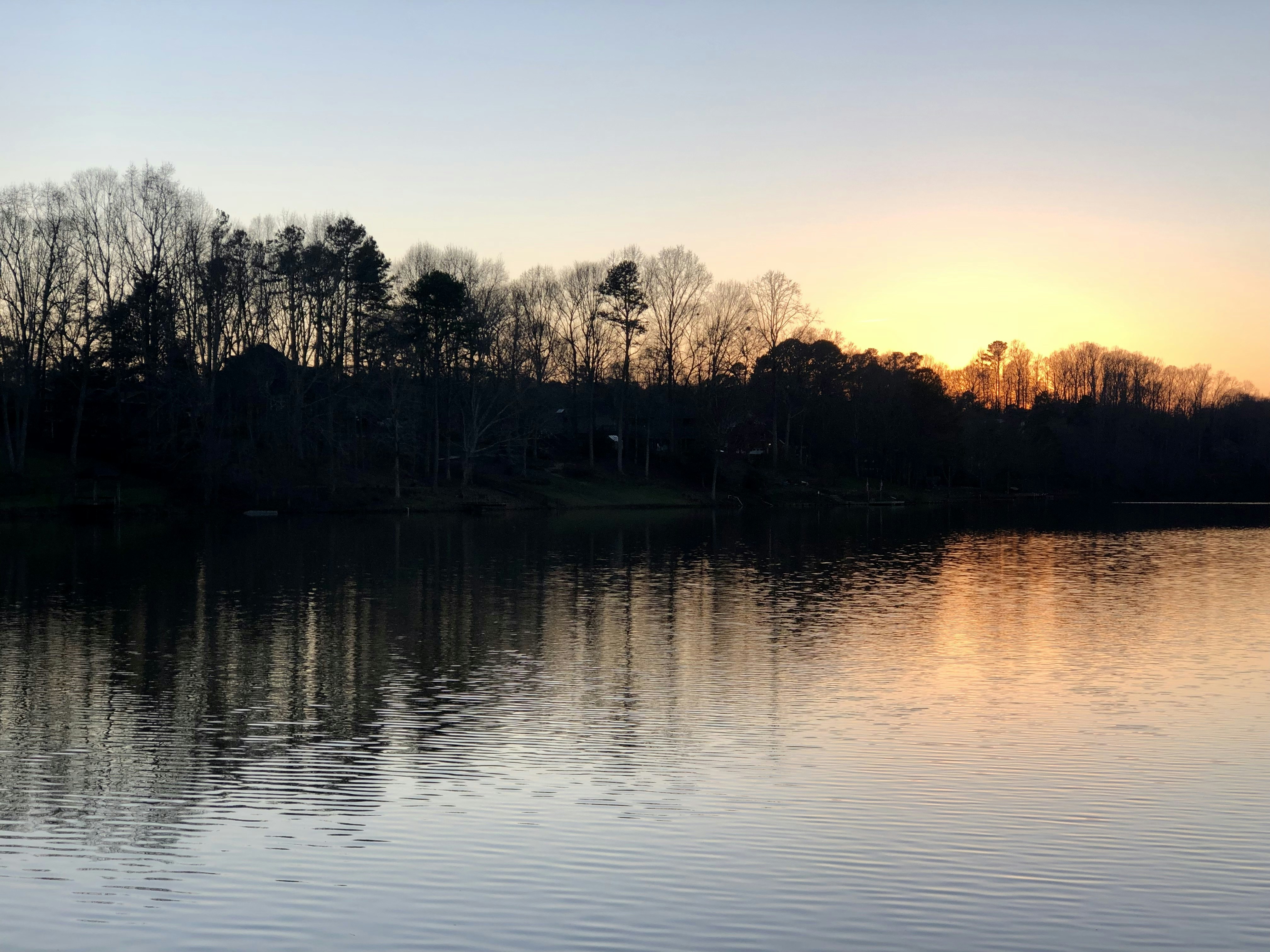 A peaceful lake at dawn, ideal for meditation.