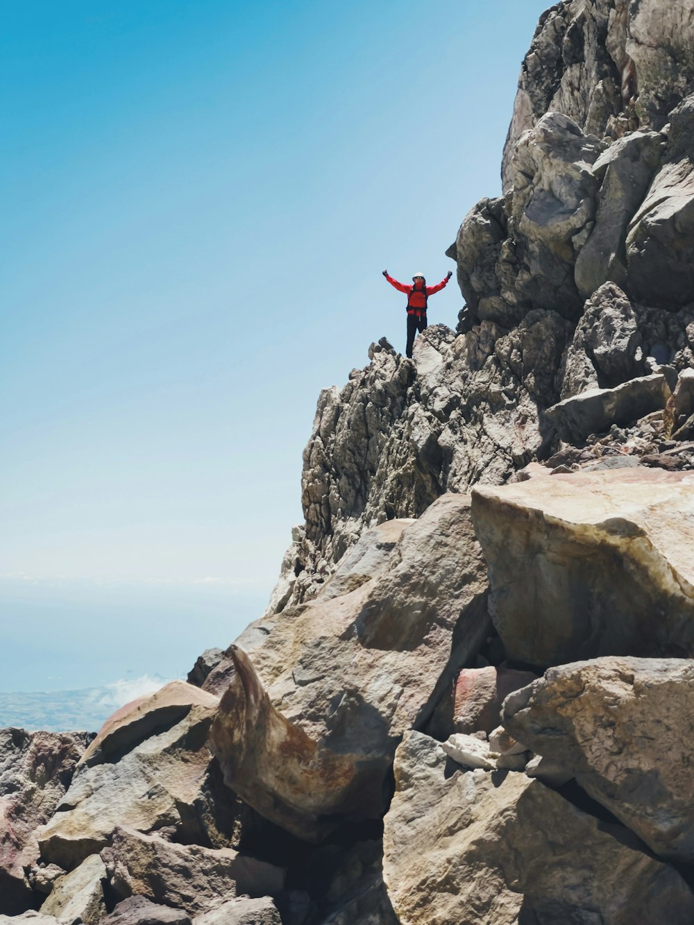 a man standing on top of a rocky cliff