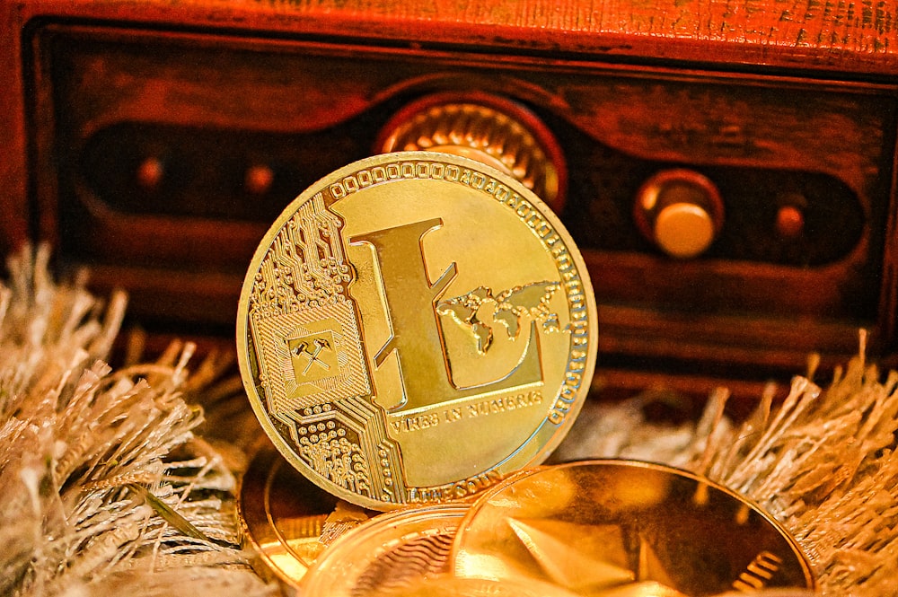 a gold coin sitting on top of a pile of feathers