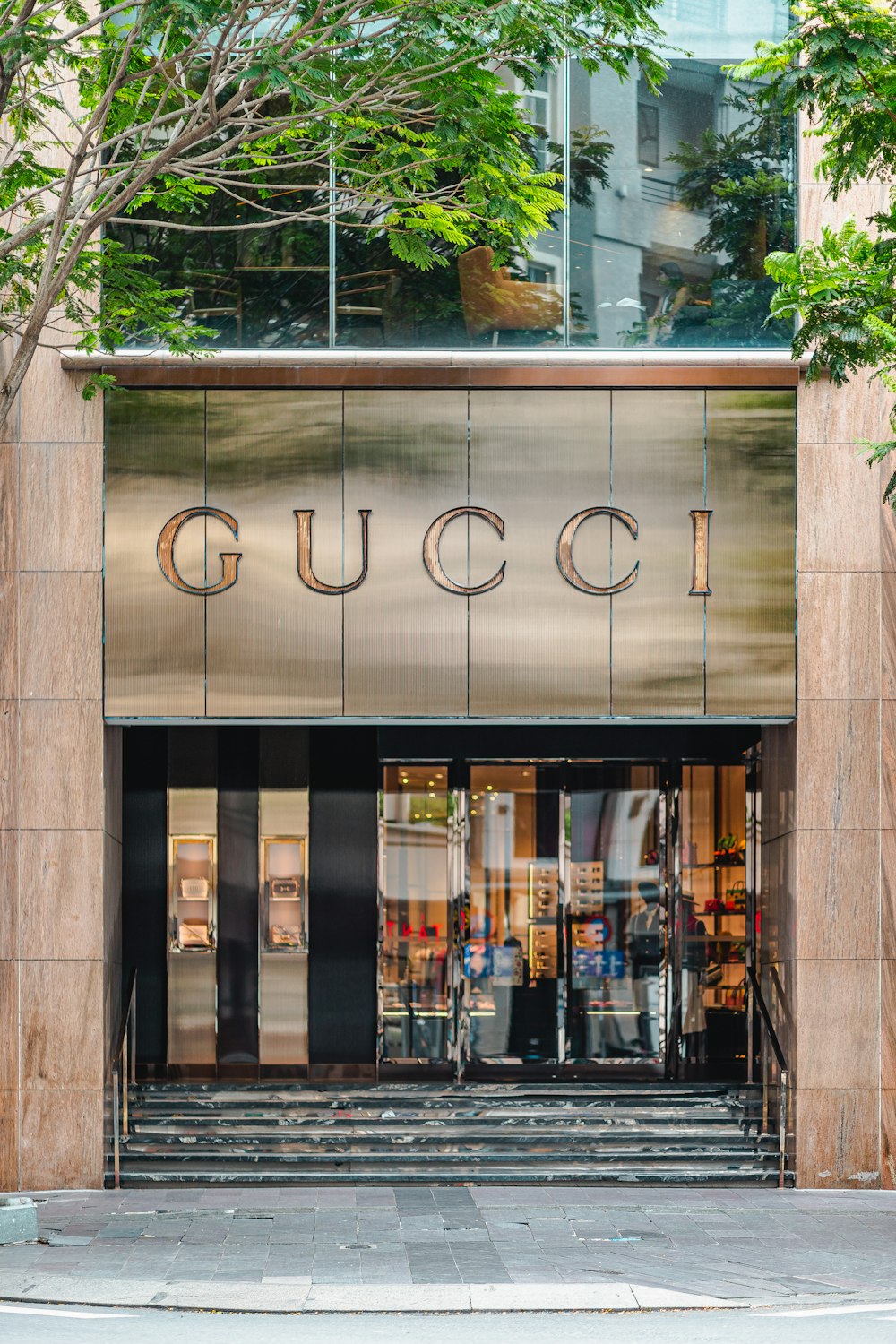 the entrance to a gucci store in a city
