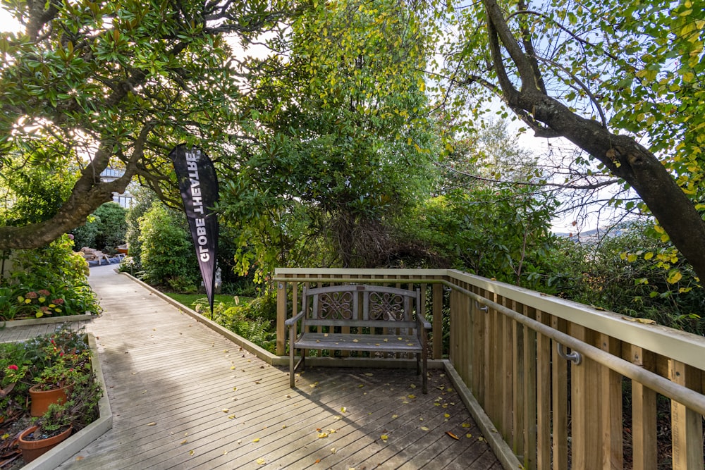 a wooden bench sitting on top of a wooden deck