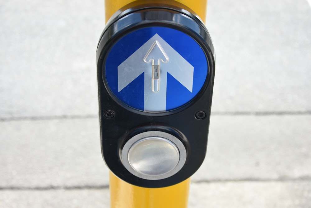 a close up of a parking meter with an arrow on it