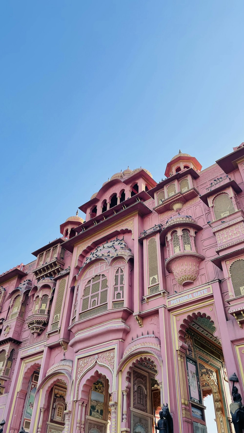 a pink building with a clock on the front of it